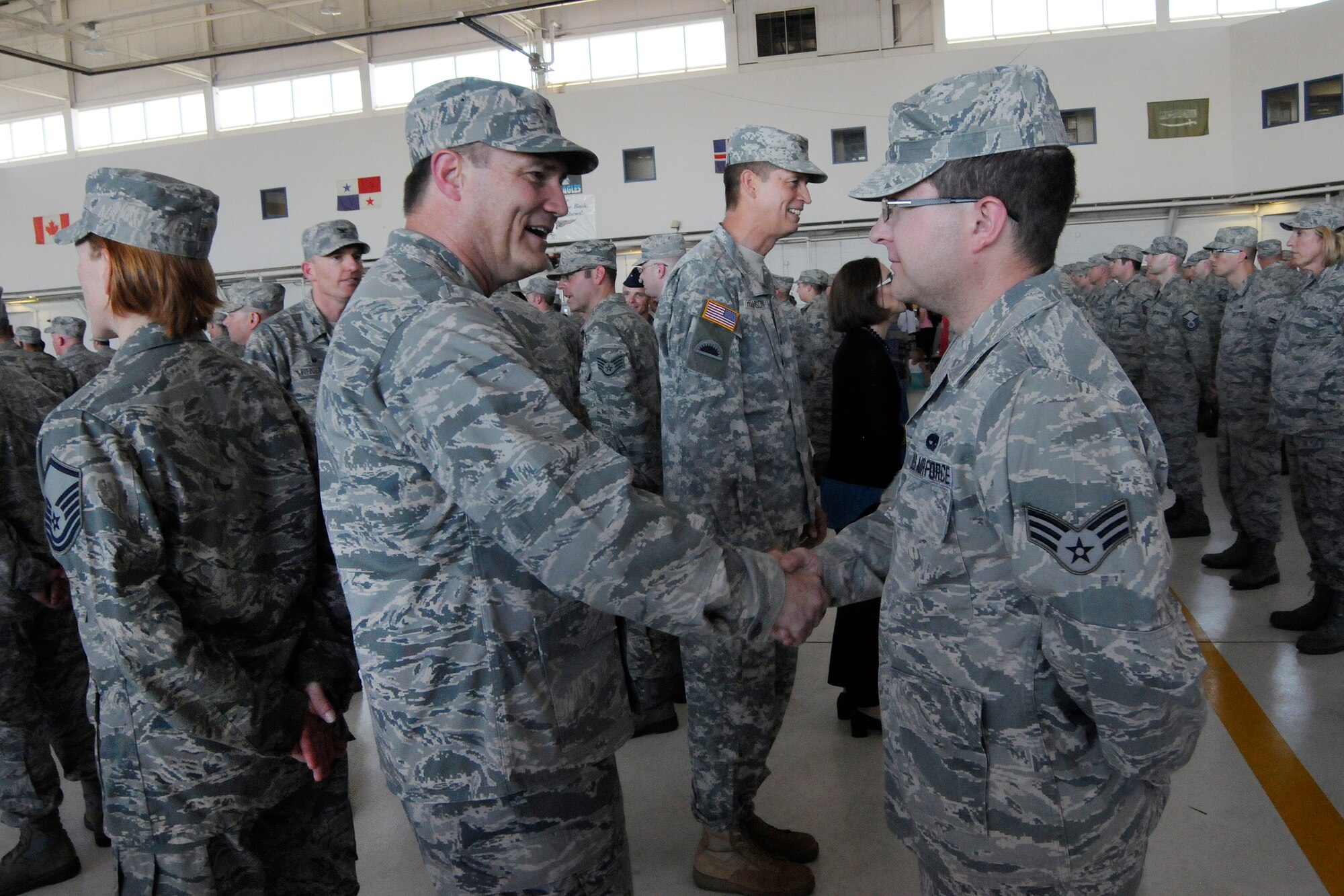 Air National Guard Brig. Gen. Michael Stencel, Oregon Air National Guard commander, left, greets Airmen deploying in support of Operation Atlantic Resolve, following the formal mobilization ceremony, June 26, 2015, Portland Air National Guard Base, Ore. (U.S. Air National Guard photo by Tech. Sgt. John Hughel, 142nd Fighter Wing Public Affairs/Released)