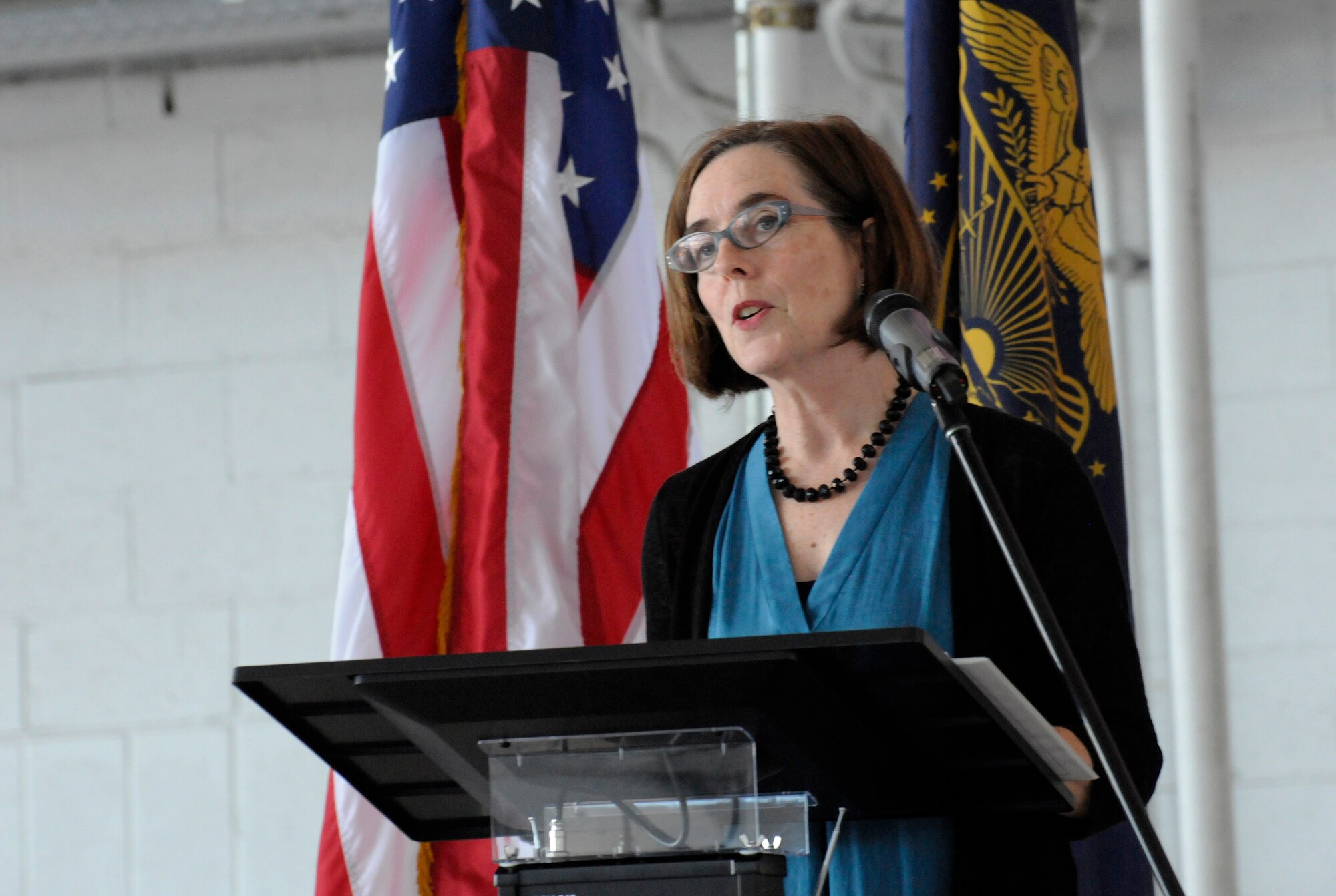 Oregon Governor Kate Brown addresses the Airmen, families and others in attendance at the 142nd Fighter Wing mobilization ceremony, June 26, 2015, Portland Air National Guard Base, Ore. The unit is deploying to Eastern Europe in support of Operation Atlantic Resolve.  (U.S. Air National Guard photo by Tech. Sgt. John Hughel, 142nd Fighter Wing Public Affairs/Released)