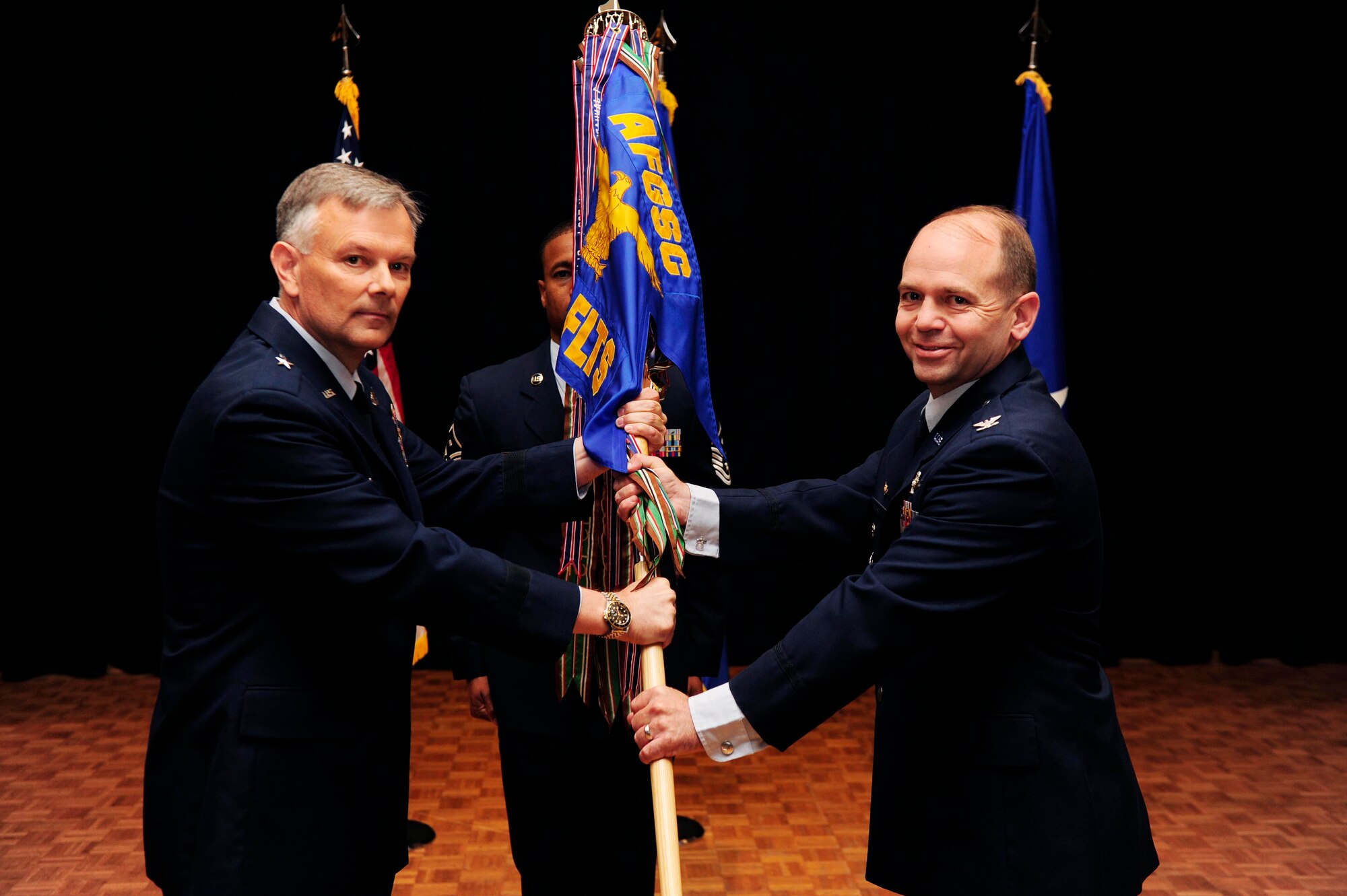 Col. Craig Ramsey accepts the 576th Flight Test Squadron flag from Brig. Gen. Glen VanHerck, Air Force Global Strike Command Director of Operations, during a change of command ceremony at Vandenberg Air Force Base, Calif., June 26, 2015. (U.S. Air Force photo/Staff Sgt. Jim Araos)