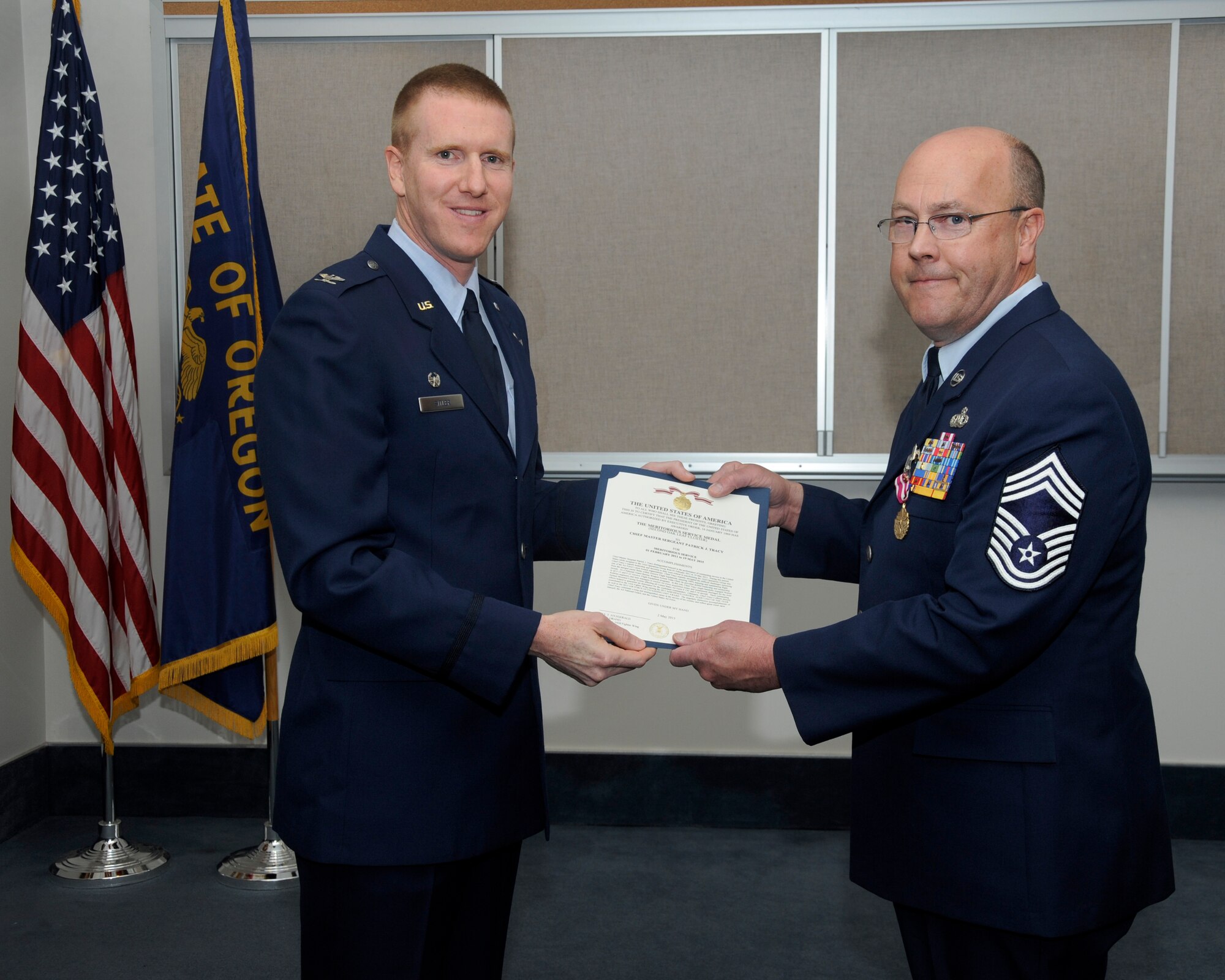 142nd Fighter Wing Operations Group Commander Col. Adam Sitler, left, present The Meritorious Service Medal to Chief Master Sgt. Patrick Tracy, 142nd Fighter Wing Operations Chief, right, during his retirement ceremony, May 2, 2015, Portland Air National Guard Base, Ore. Tracy was assigned to the 142nd Fighter Wing Operations Group, serving as the senior enlisted leader and also was the Team Chief for the Air National Guard’s F-15 Eagle Weapons System Council, Aircrew Flight Equipment. (U.S. Air National Guard by Tech. Sgt. John Hughel, 142nd Fighter Wing Public Affairs Department)