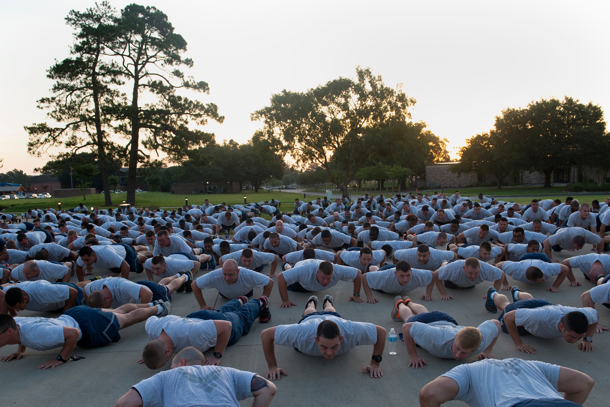 Members of the 23d Wing perform pushups before the Wing warrior run June 26, 2015, at Moody Air Force Base, Ga. Airmen performed warmup exercises before running the 2.3-mile run such as jumping jacks, squats and pushups. (U.S. Air Force photo by Airman 1st Class Kathleen D. Bryant/Released)