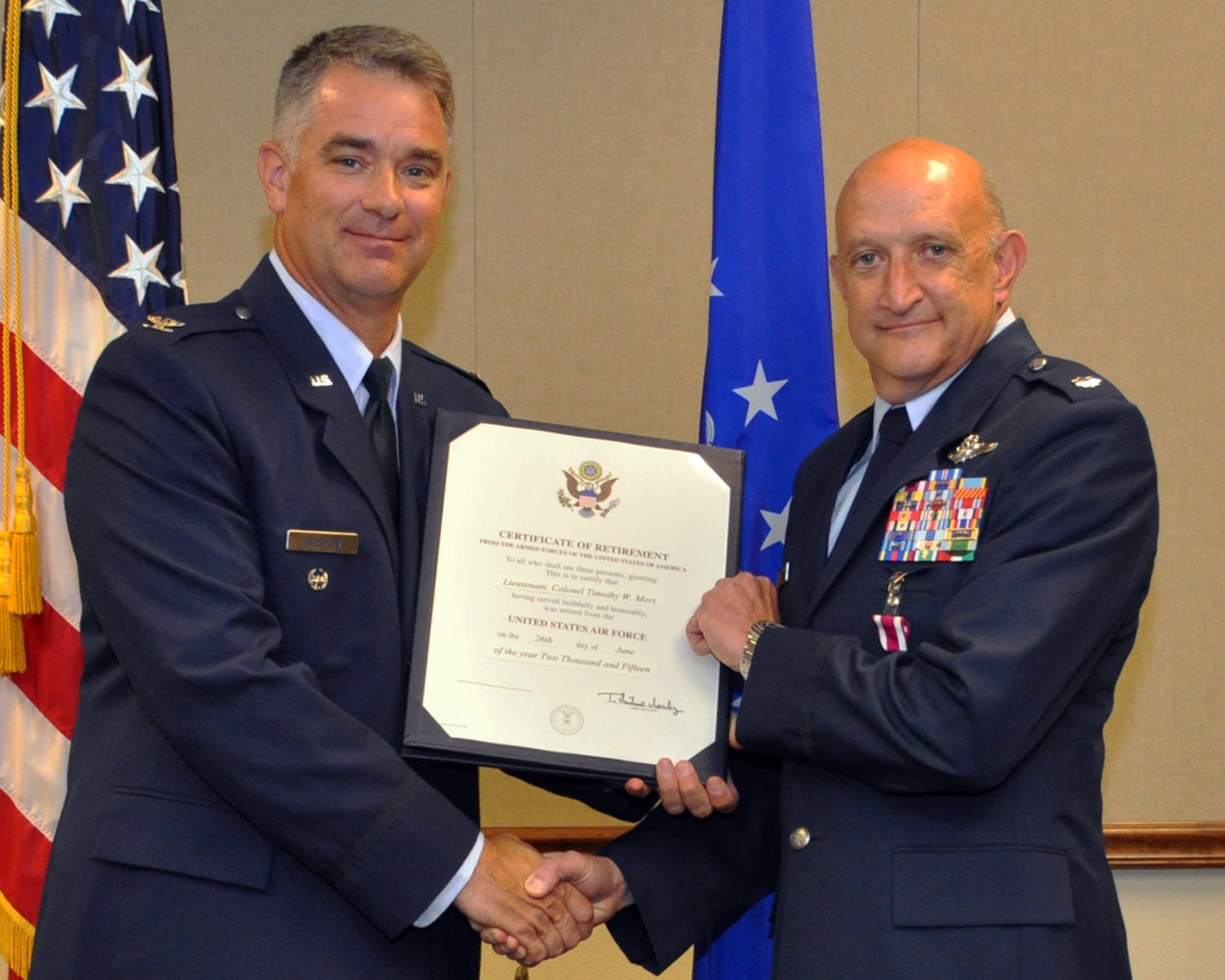 U.S. Air Force Col. David Leedom, Reserve Advisor to the 8th Air Force commander, presents Lt. Col. Tim Mers with a certificate of retirement on June 26, 2015 at Barksdale Air Force Base, La. Colonel Mers was an Instructor Weapons System Officer for the 93rd Bomb Squadron and is retiring with over 30 years of honorable service. (U.S. Air Force photo by Master Sgt. Laura Siebert/Released)