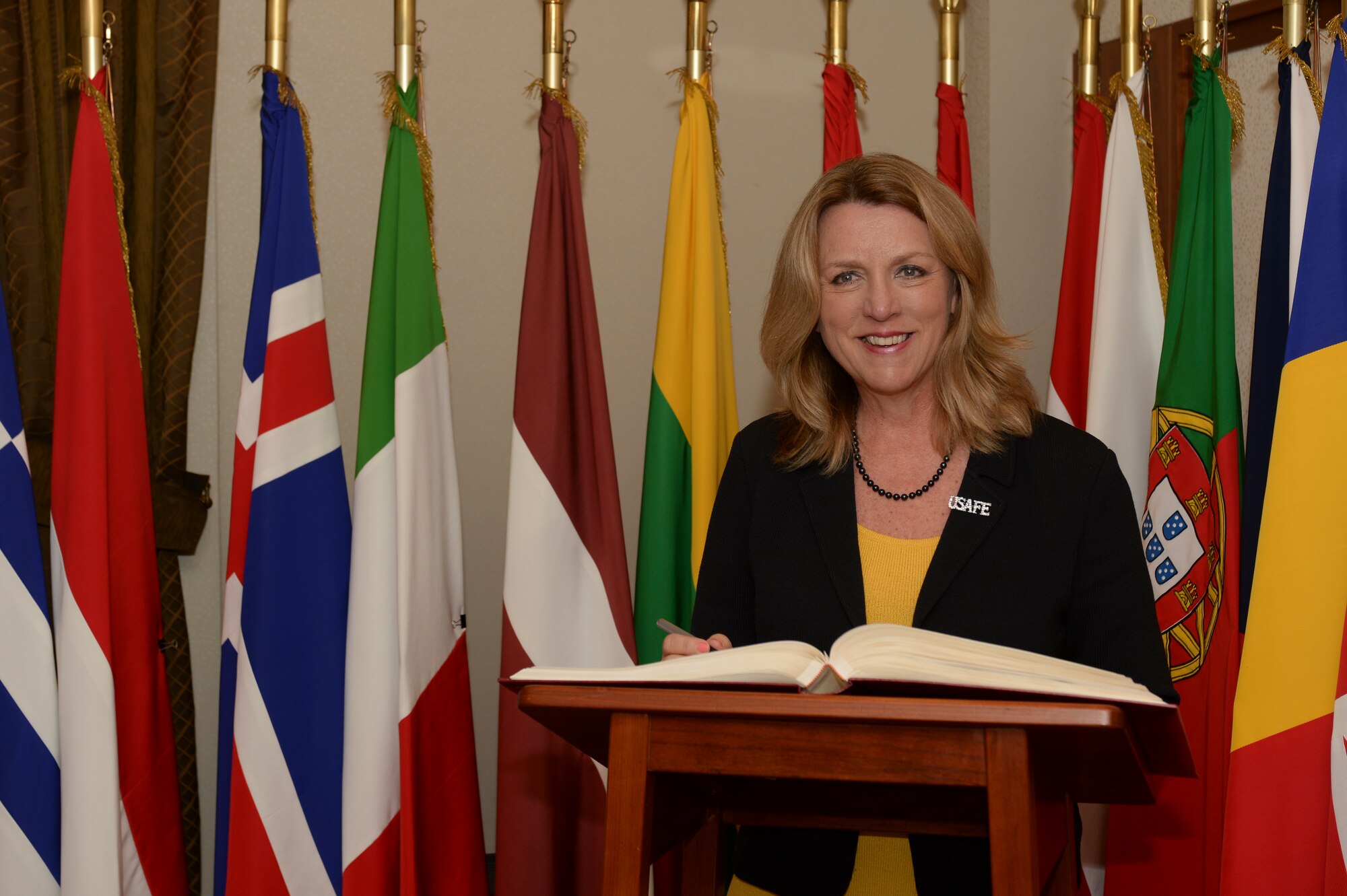 Deborah Lee James, Secretary of the U.S. Air Force, smiles as she signs a visitor book in the office of the Supreme Allied Commander Europe during her visit to Supreme Headquarters Allied Powers Europe at Mons, Belgium, June 23, 2015. The Secretary completed a visit of installations through Europe June 24, 2015, to meet Airmen, community leaders and allied and partner nation defense chiefs. (U.S. Air Force photo by Staff Sgt. Joe W. McFadden/Released)