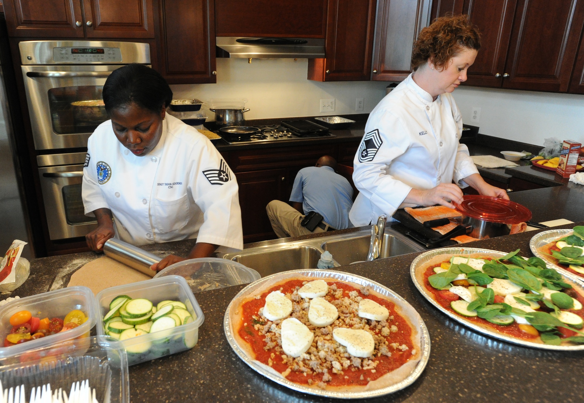 Enlisted Aides Staff Sgt. Tasha Goodrich (left) and Chief Master Sgt. Laura Kelly (right) prepare food for the Healthy Cooking Made Easy demonstration at Liberty Park Welcome Center on Joint Base Andrews, Md., June 25, 2015. (U.S. Air Force photo/ Staff Sgt. Nichelle Anderson)
