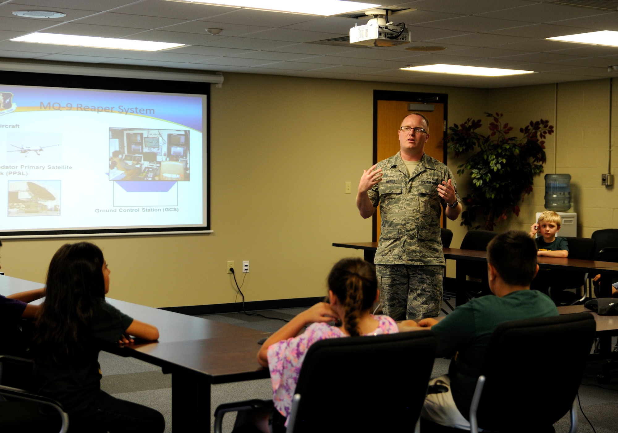 Staff Sgt. Timothy Morris briefs Choctaw Nation students at Ebbing Air National Guard Base, Ark., June 25, 2015. Morris explained how the 188th Intelligence Support Squadron provides operational ready communications equipment and personnel in support of the 188th’s Intelligence, Surveillance and Reconnaissance Group. Morris is assigned to the 188th ISS. (U.S. Air National Guard photo by Staff Sgt. Hannah Dickerson/Released)
