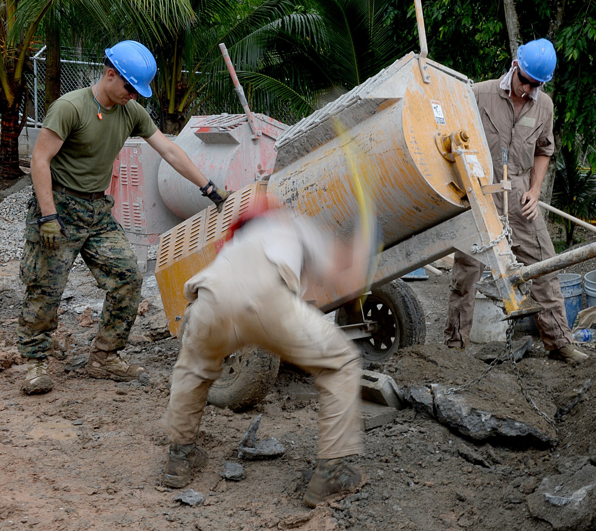 U.S. Air Force Tech. Sgt. Ryan McAllister, 823rd Expeditionary RED HORSE Squadron structural craft lead, removes hardened cement from around a mixer at the Gabriela Mistral school construction site in Ocotes Alto, Honduras, June 24, 2015. The site is home to the construction of a new two-classroom schoolhouse project and is one part of the NEW HORIZONS Honduras 2015 training exercise conducted by U.S. Southern Command. NEW HORIZONS was launched in the 1980s and is an annual joint humanitarian assistance exercise that U.S. Southern Command conducts with a partner nation in Central America, South America or the Caribbean. The exercise improves joint training readiness of U.S. and partner nation civil engineers, medical professionals and support personnel through humanitarian assistance activities. (U.S. Air Force photo by Capt. David J. Murphy/Released)