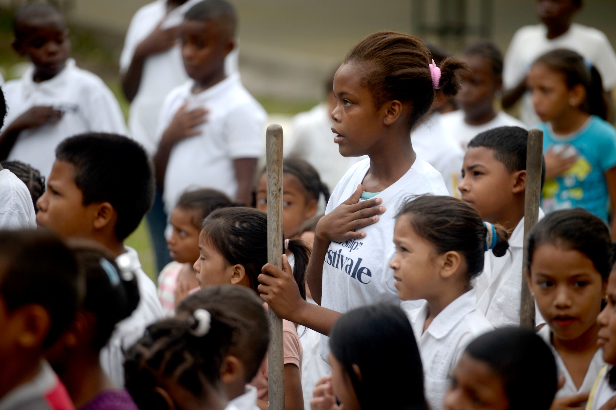 Students sing the Honduran national anthem during the National Tree Day celebration at Rafeal Peneda Ponce School in Trujillo, Honduras, June 19, 2015. NEW HORIZONS Honduras 2015 personnel were at the event in between providing support throughout the Trujillo and Tocoa regions of Honduras by building a new two-classroom schoolhouse in Ocotes Alto, drilling a well in Honduras Aguan, and proving general medical support. NEW HORIZONS was launched in the 1980s and is an annual joint humanitarian assistance exercise that U.S. Southern Command conducts with a partner nation in Central America, South America or the Caribbean. The exercise improves joint training readiness of U.S. and partner nation civil engineers, medical professionals and support personnel through humanitarian assistance activities. (U.S. Air Force photo by Capt. David J. Murphy/Released)
