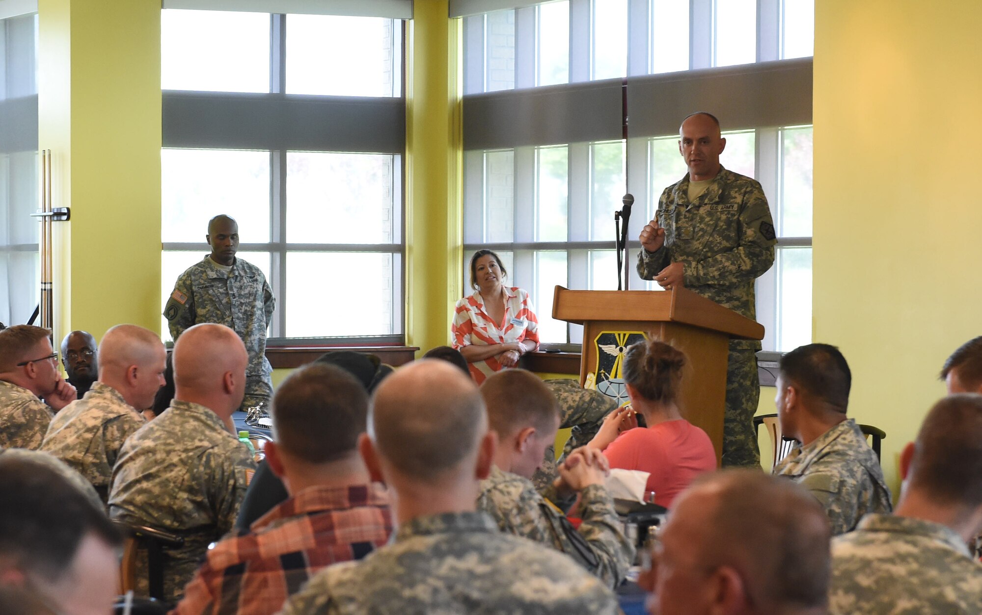 Maj. Jeremy McHugh, 743rd Military Intelligence Battalion member, speaks with U.S. Army members during the Team Buckley Military Heritage Series: Army Salute celebration June 26, 2015, at Panther Den on Buckley Air Force Base, Colo. The Army Salute, which included displays, brief presentations and free food, was held to celebrate the Army’s 240th birthday and its history on Buckley AFB. (U.S. Air Force photo by Airman 1st Class Samantha Meadors/Released)