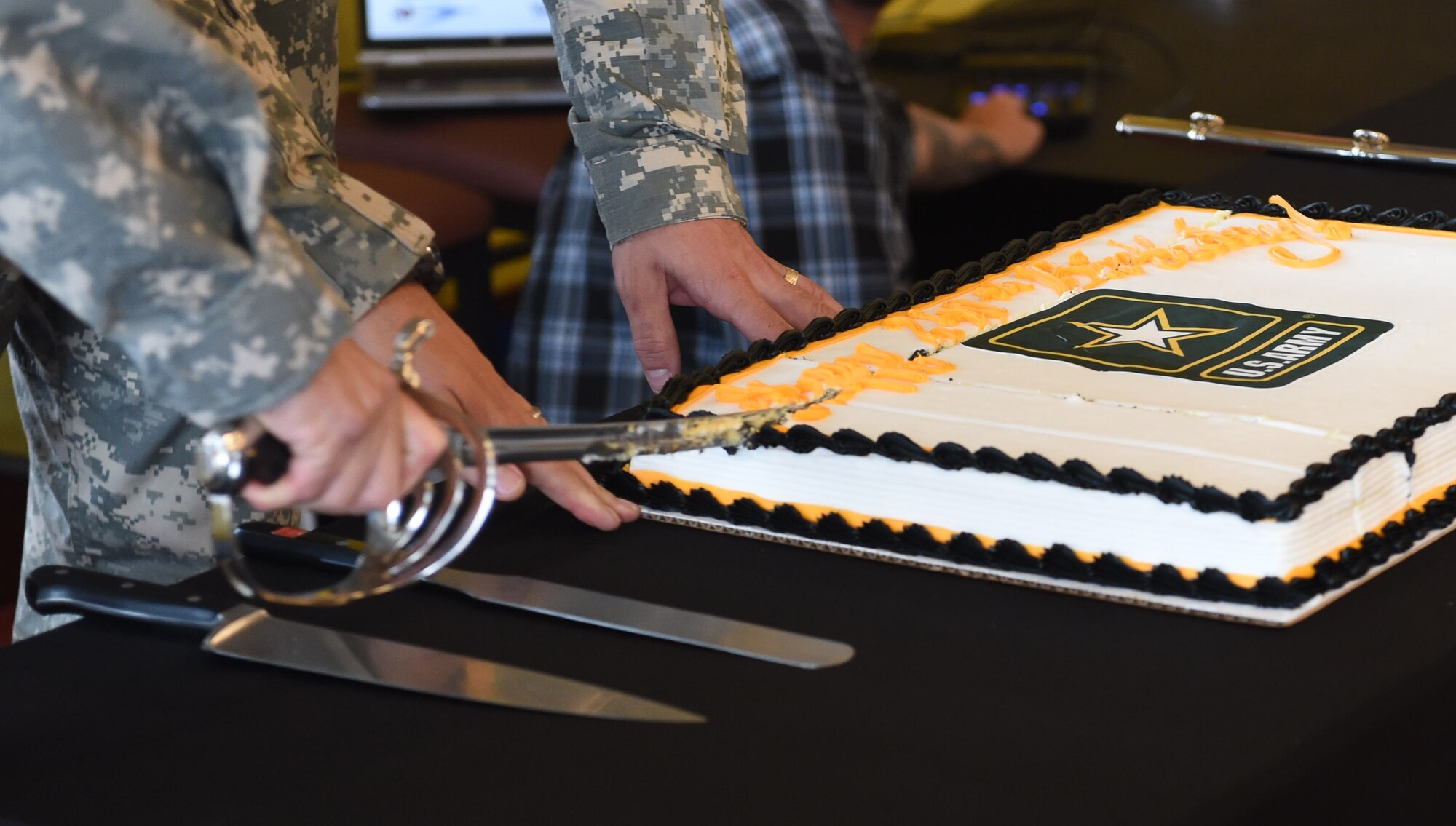 Two U.S. Army members cut the cake during the Team Buckley Military Heritage Series: Army Salute celebration June 26, 2015, at Panther Den on Buckley Air Force Base, Colo. The Army Salute, which included displays, brief presentations and free food, was held to celebrate the Army’s 240th birthday and its history on Buckley AFB. (U.S. Air Force photo by Airman 1st Class Samantha Meadors/Released)