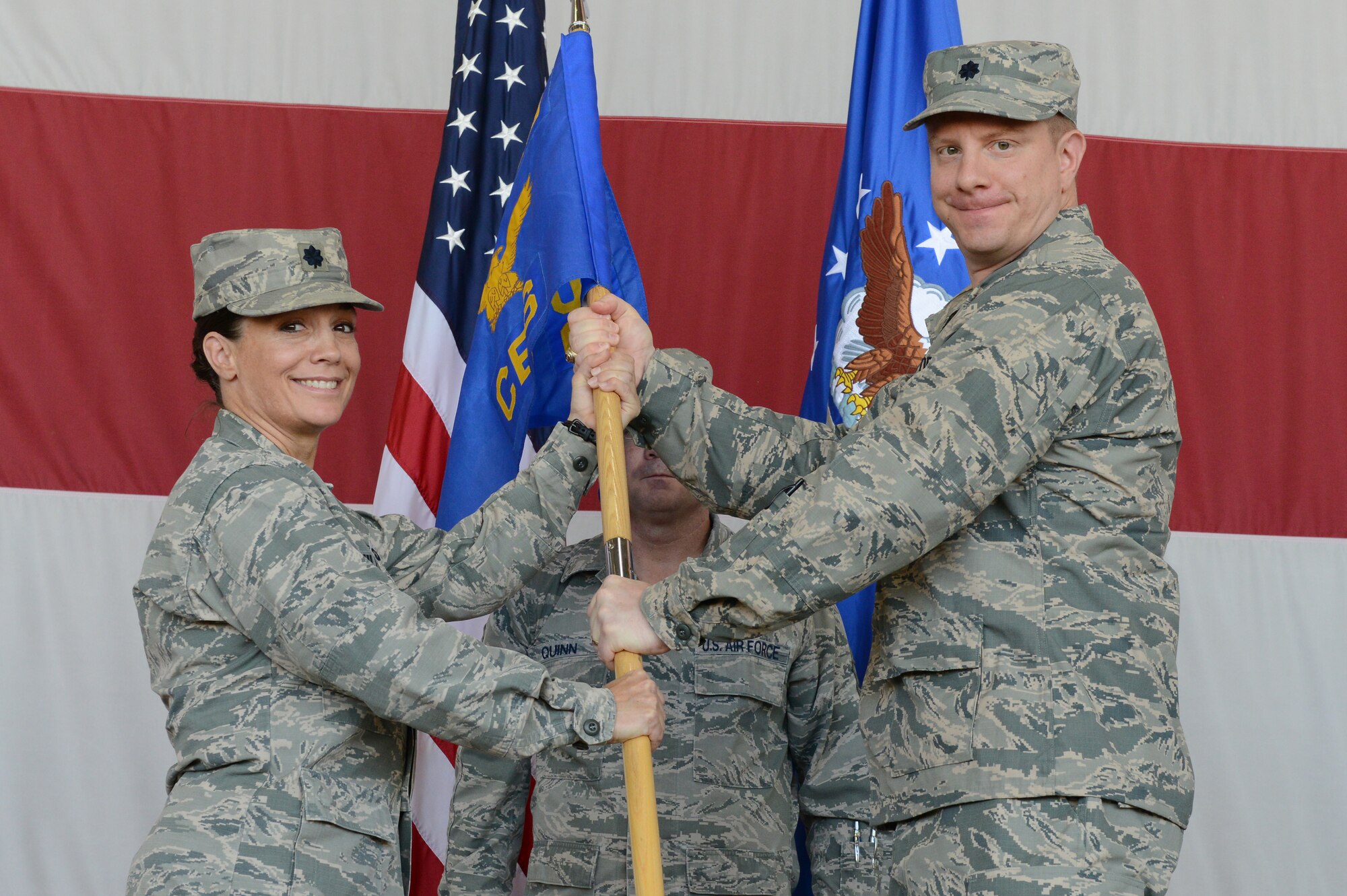 Lt. Col. Carol Miller, 56th Mission Support Group deputy commander, passes the guidon to Lt. Col. Gregory Mayer, incoming 56th Civil Engineer Squadron commander, June 17 at Luke Air Force Base.  