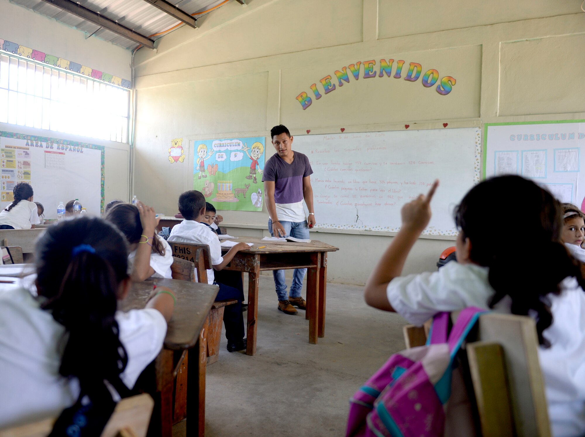 Cristian Suazo teaches Gabriela Mistral third grade math at the Gabriela Mistral School in Ocotes Alto, Honduras, June 16, 2015. Gabriela Mistral is the site of a new two-room classroom being built by U.S. Air Force Airmen from the 823rd Expeditionary RED HORSE Squadron, and U.S. Marines from the 271st Marine Wing Support Squadron, 2nd Marine Air Wing, as part of the NEW HORIZONS Honduras 2015 training exercise going on throughout the Trujillo and Tocoa, Honduras regions. NEW HORIZONS was launched in the 1980s and is an annual joint humanitarian assistance exercise conducted by U.S. Southern Command with a partner nation in Central America, South America or the Caribbean. The exercise improves joint training readiness of U.S. and partner nation civil engineers, medical professionals and support personnel through humanitarian assistance activities. (U.S. Air Force photo by Capt. David J. Murphy/Released)