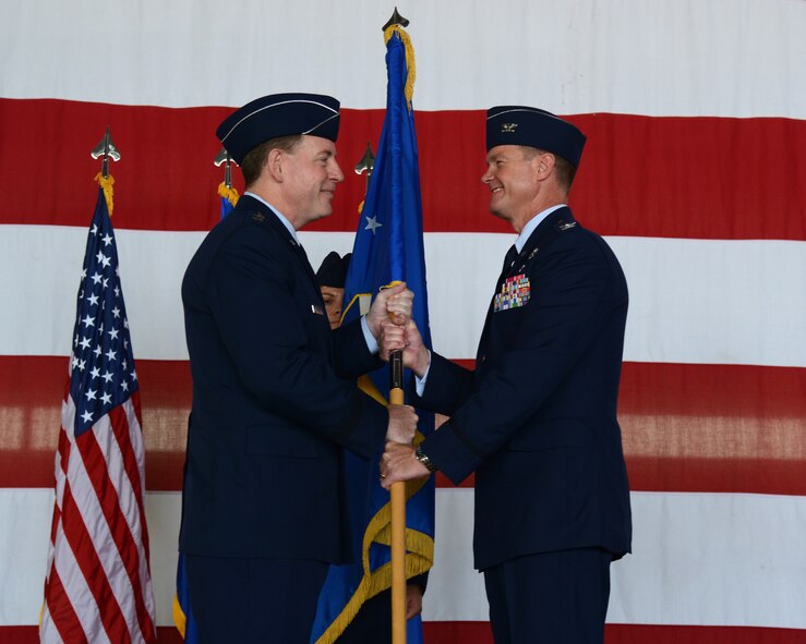 Maj. Gen. James B. Hecker, commander of 19th Air Force, presents the unit guidon to Col. Thomas Shank during the 47th Flying Training Wing change of command ceremony at Laughlin Air Force Base Texas, June 29, 2015. The 47th FTW conducts specialized undergraduate pilot training for the United States Air Force, Air Force Reserve, Air National Guard and allied nation air forces utilizing the T-6 Texan, T-38 Talon and T-1A Jayhawk aircraft while deploying mission-ready Airmen as well as develop professional, disciplined bold leaders. (U.S. Air Force photo by Airman 1st Class Ariel D. Partlow)