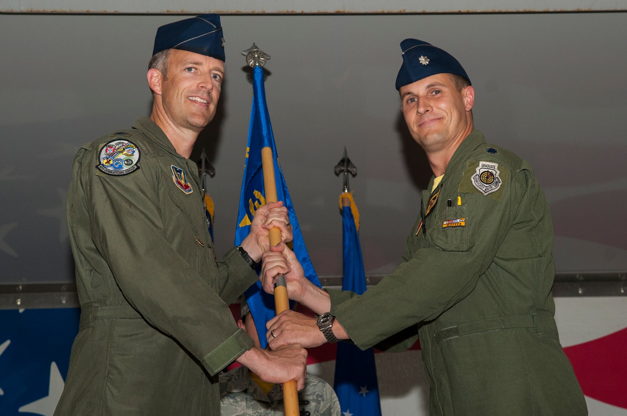 Col. Brian Afflerbaugh, 4th Operations Group commander, passes the guidon to Lt. Col. Lucas Teel, incoming 336th Fighter Squadron  commander, June 26, 2015, at Seymour Johnson Air Force Base, North Carolina. Teel previously served as the 335th FS director of operations before assuming command of the 336th FS. (U.S. Air Force photo/Airman Shawna L. Keyes)  