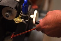 A member from the 341st Civil Engineer Squadron structures shop cuts groves for a new building key June 26, 2015, at Malmstrom Air Force Base, Mont. The 341st CES operates, constructs, and maintains major facilities valued at $2.2 billion, and missile complex site facilities valued at $1.6 billion covering 13,800 square miles. (U.S. Air Force photo/Chris Willis)