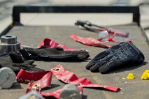 A hand cart carrying tools belonging to the 5th Munitions Squadron holds an Airman’s work-gloves after assembling inert GBU-38 bombs at Minot Air Force Base, N.D., June 25, 2015. The inert munitions were assembled as practice for the bomb building portion of the Air Force Global Strike Challenge. (U.S. Air Force photo/Airman 1st Class Justin T. Armstrong)