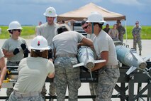 Airmen from the 5th Munitions Squadron train for the Global Strike Challenge by attaching Joint Direct Attack Munition guidance kits to inert unguided free-fall bombs at Minot Air Force Base, N.D., June 25, 2015.  At the 2014 GSC, Team Minot was awarded the Innovation Trophy along with a $100,000 check. (U.S. Air Force photo/Airman 1st Class Justin T. Armstrong)