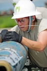 Airman Devon Stearns, a 5th Munitions Squadron conventional maintenance crew member, inserts a FMU-152 into an inert GBU-38 at Minot Air Force Base, N.D., June 25, 2015.  Stearns along with her team will be participating in the 5th annual Global Strike Challenge at Barksdale AFB, L.A. (U.S. Air Force photo/Airman 1st Class Justin T. Armstrong)