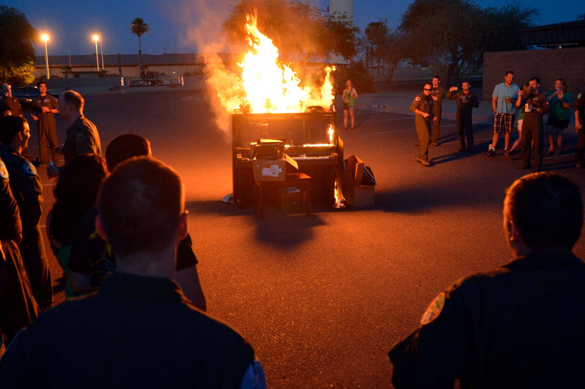The 308th Fighter Squadron watches as the piano burns during the 308th Fighter Squadron inactivation party June 12 at Luke Air Force Base. The 308th FS and aircraft maintenance unit have packed up and are transitioning to the 314th FS standing up in July at Holloman Air Force Base, New Mexico. They will be the second F-16 Fighting Falcon unit at Holloman.  (U.S. Air Force photo by SrA. Devante Williams)