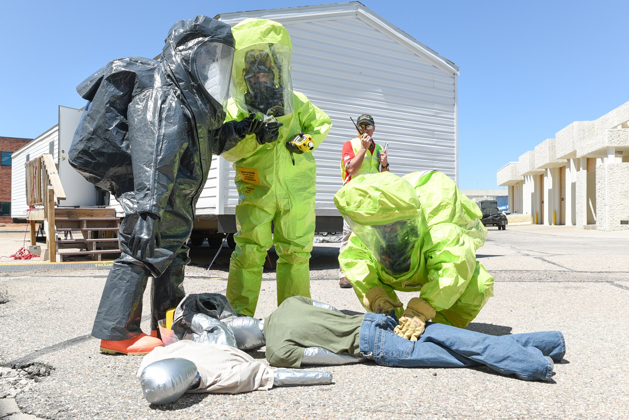 U.S. Air Force Staff Sgt. Farooq Durrani, 153rd Bioenvironmental Engineering, Senior Airman Collin Holte, 153rd Emergency Management, and Brent Osborne, Cheyenne Region 7 Hazmat, tend to simulated chlorine contaminated victims, June 19, 2015, at Cheyenne Air National Guard Base in Cheyenne, Wyo. Durrani, Holte, and Osborne are participating in Counter-CBRN All-Hazard Management Response (CAMR) training with civilian and military first responders to practice chemical, biological, radiological, first response, medical, and incident command scenarios for possible threats in the region. (U.S. Air National Guard photo by Master Sgt. Charles Delano)