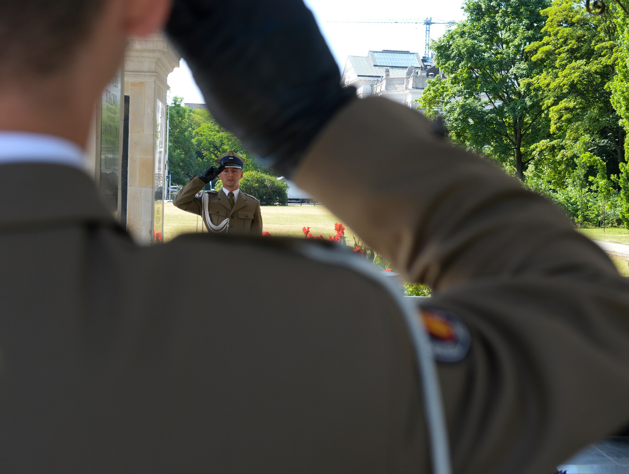 Two Polish air force ceremonial guardsmen salute each other during a wreath-laying ceremony at the Tomb of the Unknown Soldier in Warsaw, Poland, June 22, 2015. Deborah Lee James, Secretary of the U.S. Air Force, completed a visit of installations through Europe June 24, 2015, to meet Airmen, community leaders and allied and partner nation defense chiefs. (U.S. Air Force photo by Staff Sgt. Joe W. McFadden/Released)