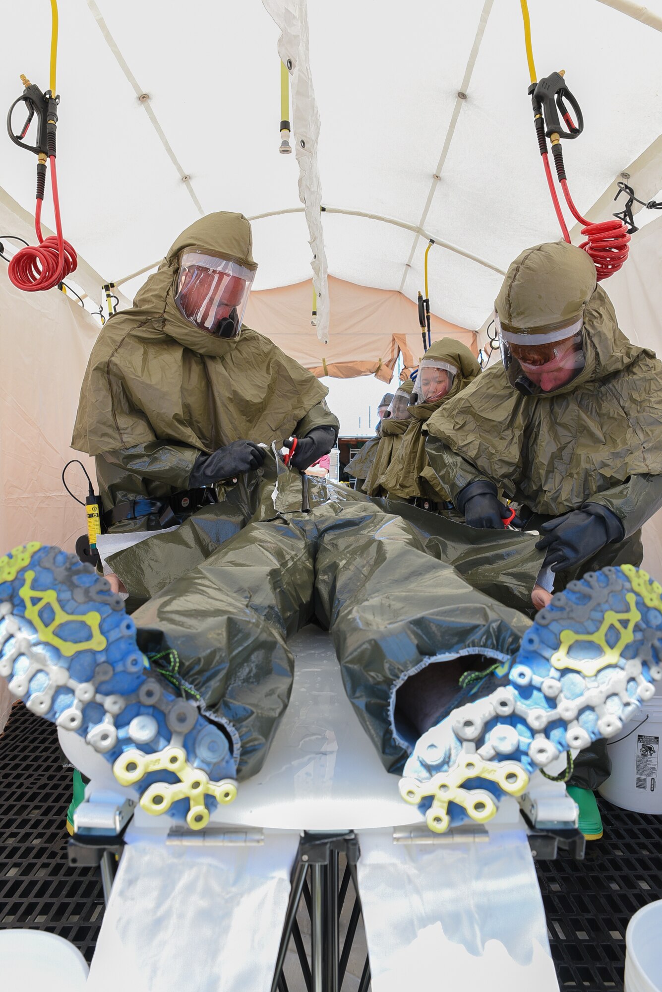 Airmen assigned to the 153rd Medical Group, decontaminate a simulated chlorine contaminated victim, June 19, 2015, at Cheyenne Air National Guard Base in Cheyenne, Wyo. The medical group is participating in Counter-CBRN All-Hazard Management Response (CAMR) training with civilian and military first responders to practice chemical, biological, radiological, first response, medical, and incident command scenarios for possible threats in the region. (U.S. Air National Guard photo by Master Sgt. Charles Delano)