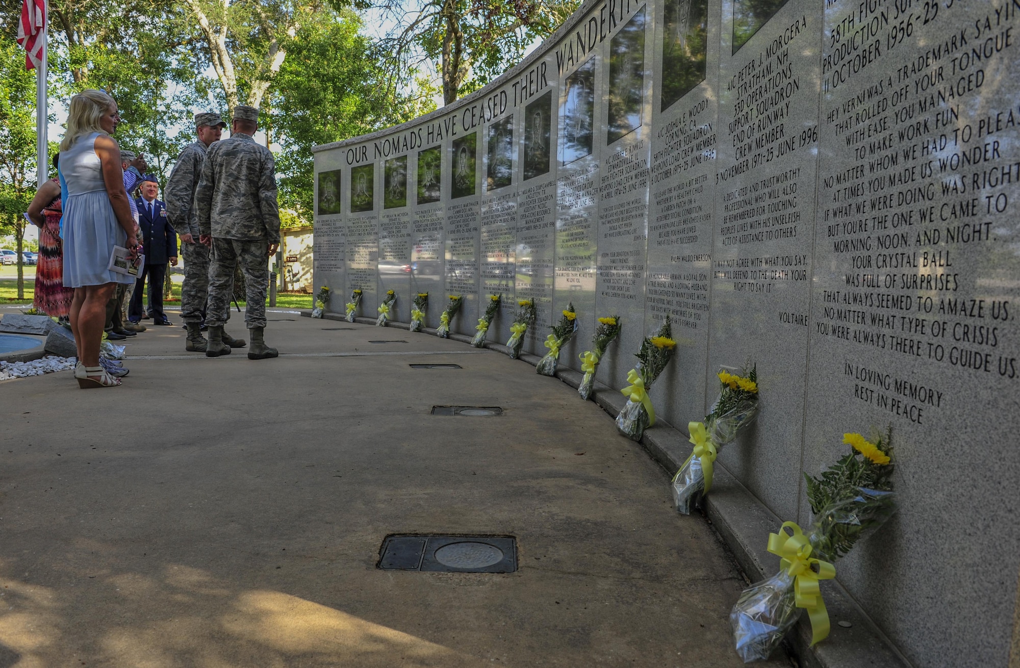Members of the 33rd Fighter Wing, family and friends of those killed during the Khobar Towers terrorist attack pay their respects during a memorial ceremony June 25 on Eglin Air Force Base, Fla. On June 25, 1996, a truck-bomb was detonated adjacent to Khobar Tower in Dhahran, Saudi Arabia, that resulted in 400 injured U.S. and international military and civilian members. The 12 Nomads honored at the ceremony were members of the 58th Fighter Squadron, 60th Fighter Squadron, 33rd Logistics Group, 33rd Maintenance Squadron and the 33rd Operations Support Squadron. They represented a cross-section of the wing as crew chiefs, expeditors, weapons loaders, mechanics, production superintendents, program managers and technicians. The memorial here honoring the Nomads’ memory was dedicated a year after the tragedy. (U.S. Air Force photo/Staff Sgt. Marleah Robertson) 
