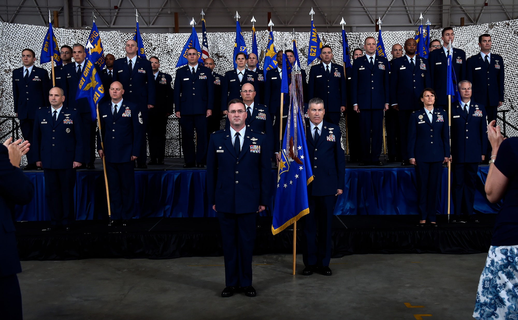 621st Contingency Response Wing leadership represent the newly reorganized wing structure during the 621 reorganization capstone ceremony at Joint Base McGuire-Dix-Lakehurst, N.J., June 26, 2015. The bicoastal wing--with units stationed here and at Travis Air Force Base, California—previously had a total of six groups consisting of four contingency response groups and two contingency operation support groups. With these six groups now inactivated, three new groups now consolidate the capacity and capability to respond to world-wide contingencies at a moment’s notice with no decrease in resources or capability: the 821st Contingency Response Group located at Travis AFB, and the 621st Contingency Response Group and 621st Air Mobility Advisory Group located at JB MDL. (U.S. Air Force photo by Tech. Sgt. Matthew Hannen)