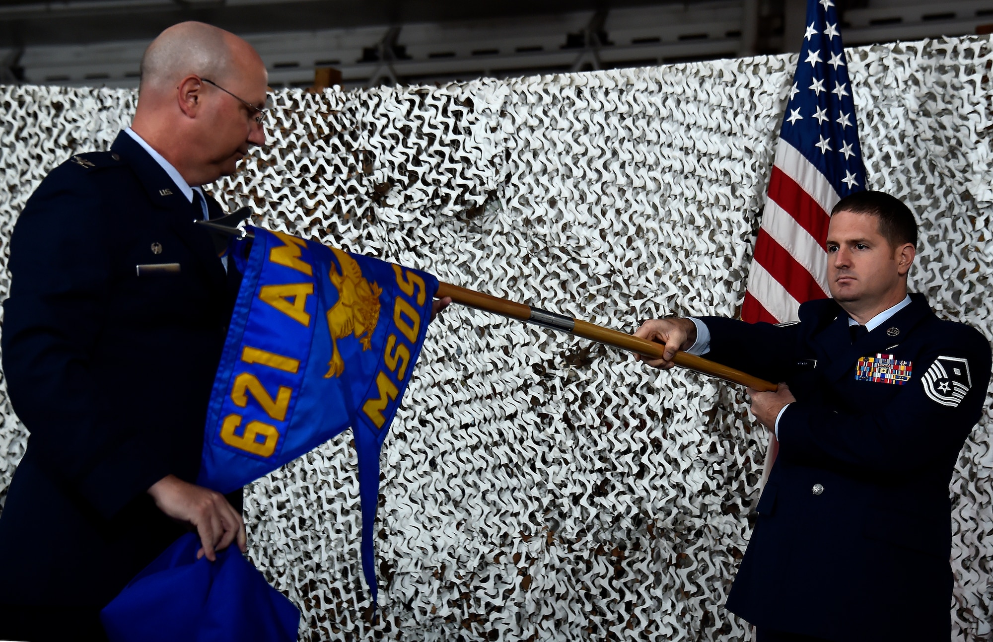 Col. Robert Levin, left, 621st Air Mobility Advisory Group commander, unfurls the squadron guidon of the newly activated 621st Mobility Support Operations Squadron during a ceremony at Joint Base McGuire-Dix-Lakehurst, N.J., June 26, 2015. The ceremony marked the establishment of the first-ever squadron dedicated to Air Mobility Command’s Air Mobility Liaison Officers. Though AMLOs from the newly formed 621 MSOS are assigned worldwide alongside Joint and combined counterparts, the 621 MSOS provides a centralized command to develop, equip and assist with AMC AMLO requirements and taskings across the globe. (U.S. Air Force photos by Tech. Sgt. Matthew Hannen)