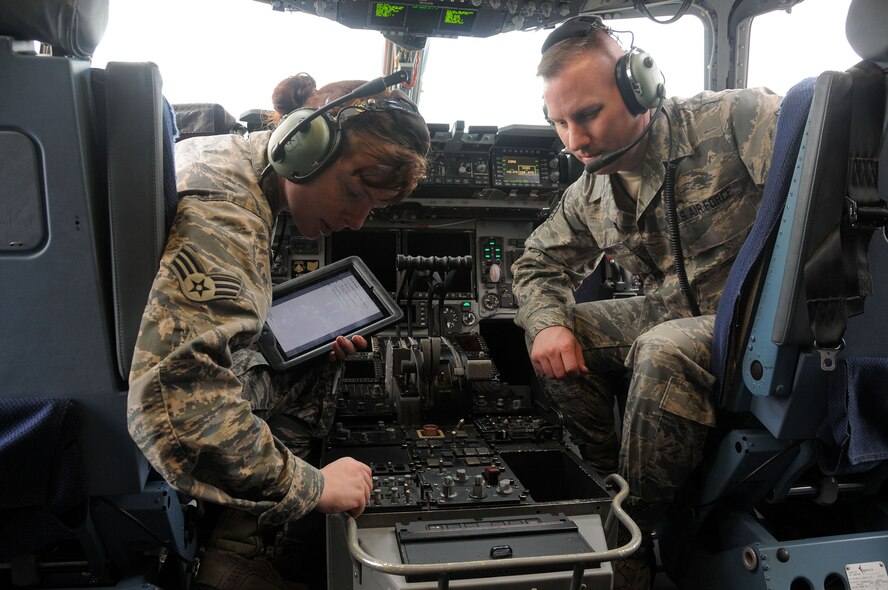 WRIGHT-PATTERSON AIR FORCE BASE, Ohio – Senior Airman Bethany Fowle, a communications/navigations specialist assigned to the 445th Aircraft Maintenance Squadron, performs an operational check on the flight interphone system of a C-17 Globemaster III as part of familiarization training while her supervisor, Staff Sgt. John Devore, looks on at Wright-Patterson Air Force Base, Ohio, June 6, 2015. (U.S. Air Force Photo/Tech. Sgt. Anthony G. Springer)