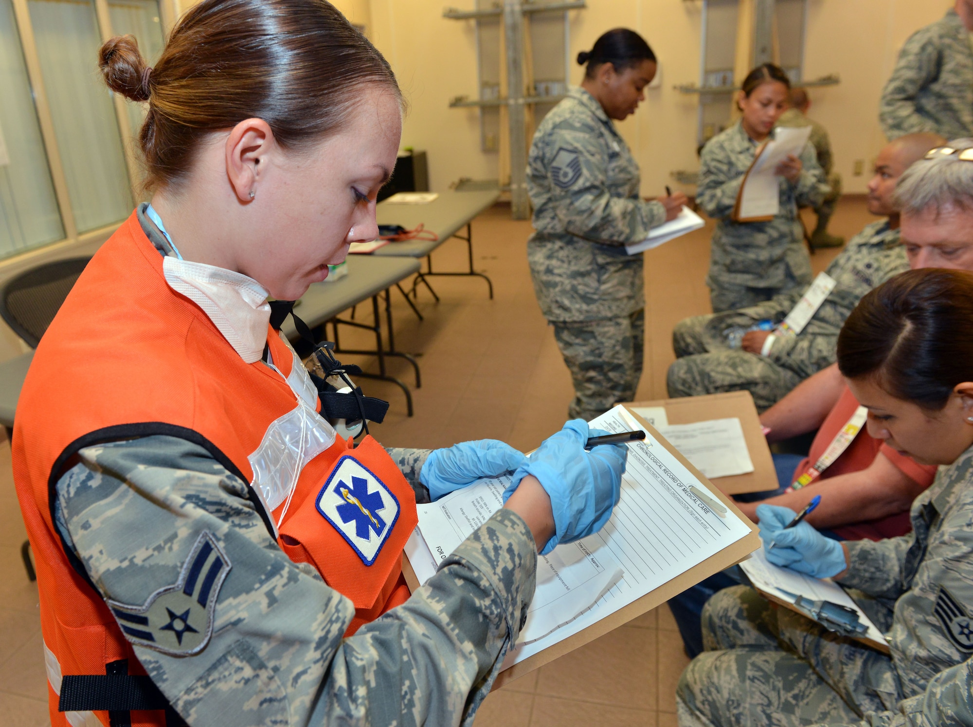 Airman 1st Class Jessica Hoyle, 39th Medical Operations Squadron medical technician, fills out a patient’s medical form during a mass accident response exercise June 25, 2015, at Incirlik Air Base, Turkey. As part of the exercise, medical personnel were tested on their ability to process a large amount of injured patients a one time. (U.S. Air Force photo by Senior Airman Michael Battles/Released)