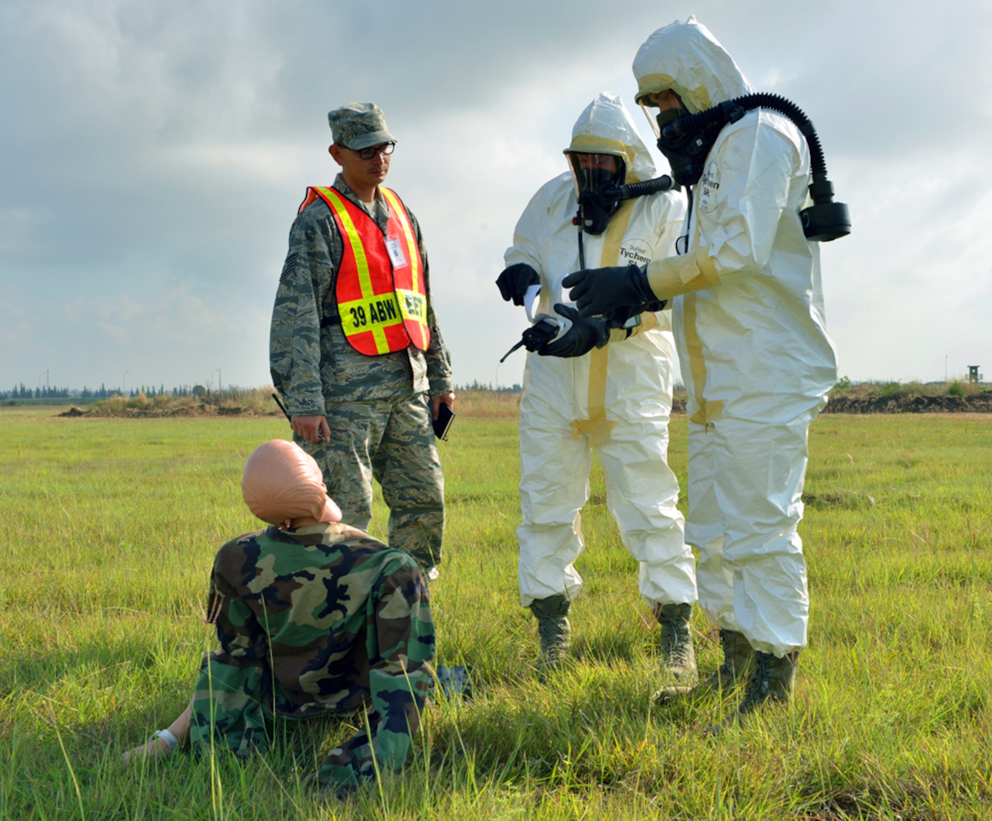 Airmen from the 39th Civil Engineer Squadron Explosive Ordnance Disposal team, inspect a medical dummy for injuries during a mass accident response exercise June 25, 2015, at Incirlik Air Base, Turkey. As part of the exercise, EOD surveyed a simulated aircraft site looking for injured personnel, equipment and potential hazards. (U.S. Air Force photo by Senior Airman Michael Battles/Released)