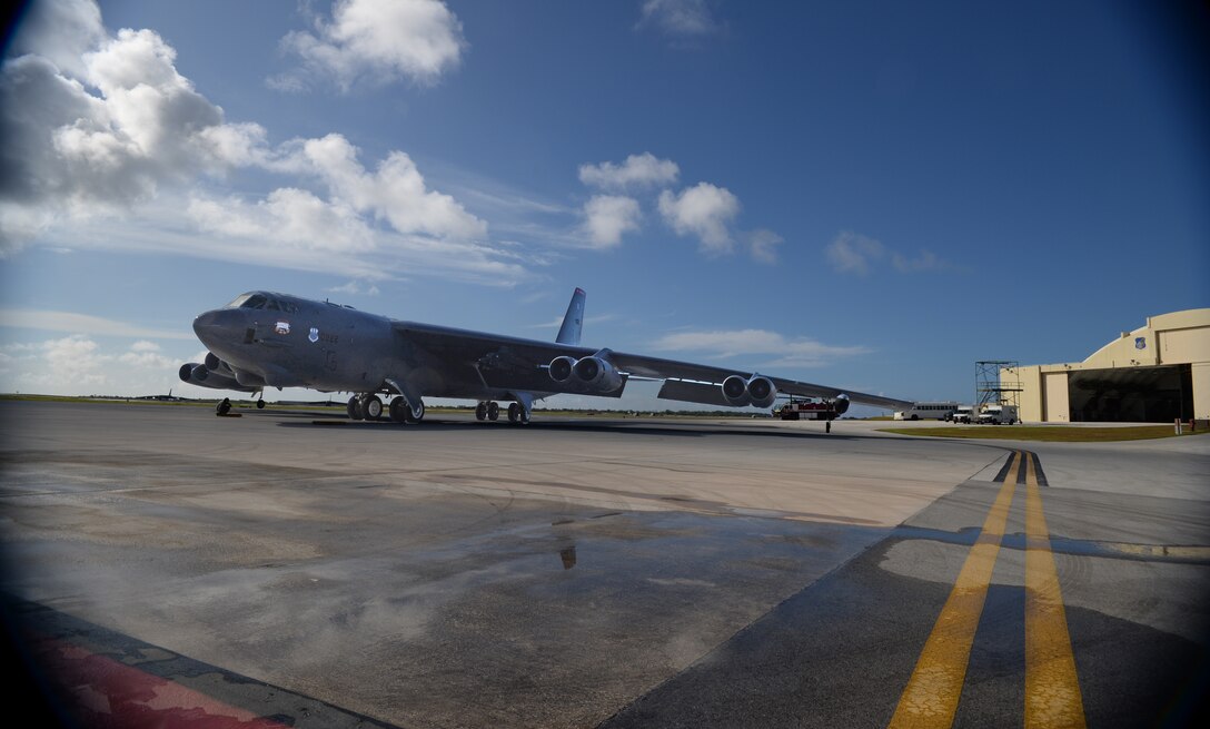 Col. Reid Langdon, 36th Operations Group commander, returns from his fini-flight aboard a B-52 Stratofortress June 25, 2015, at Andersen Air Force Base, Guam. The fini-flight reception honors aviators’ careers and includes a celebratory toast and dowsing with water for the aircraft and aircrew. (U.S. Air Force photo by Senior Airman Alexander W. Riedel/Released)