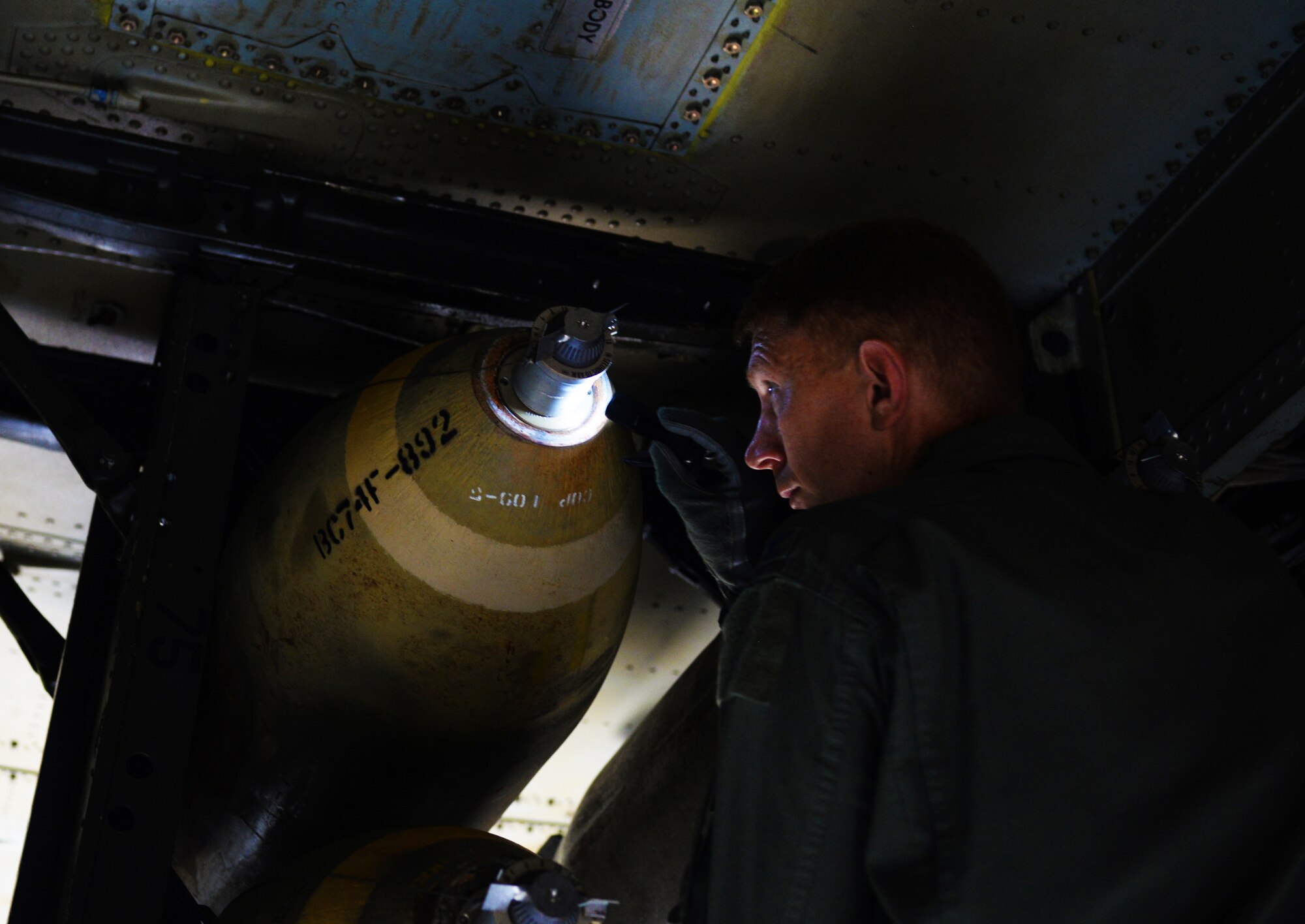 Col. Reid Langdon, 36th Operations Group commander, checks an M117 fuse in a B-52 Stratofortress bomb bay before launching his fini-flight June 25, 2015, at Andersen Air Force Base, Guam. During his last official flight as a master navigator, Langdon’s crew dropped the munitions during a training mission. (U.S. Air Force photo by Senior Airman Alexander W. Riedel/Released)