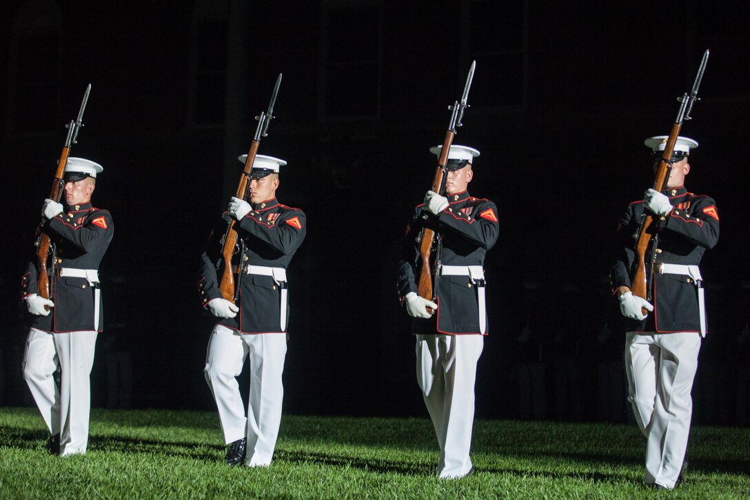 The U.S. Marine Corps Silent Drill Platoon performs during an evening parade at Marine Barracks Washington, D.C., June 26, 2015. The Honoroable Mr. Pete Visclosky and Mr. Rodney P. Frelinghuysen  were the guests of honor for the parade and Lt. Gen. Glenn M. Walters was the hosting official for that same parade. The Evening Parade summer tradition began in 1934 and features the Silent Drill Platoon, the U.S. Marine Band, the U.S. Marine Drum and Bugle Corps and two marching companies. More than 3,500 guests attend the parade every week.