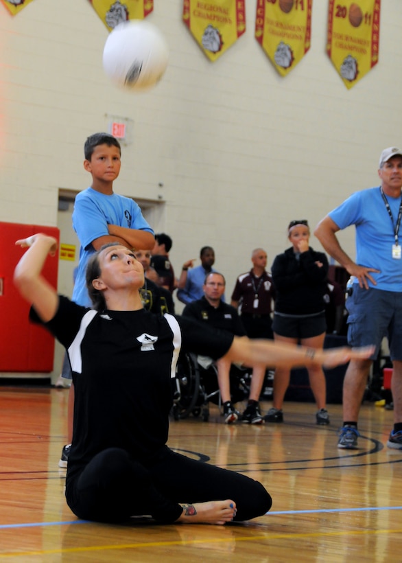 Medically retired Army Staff Sgt. Randi Gavell serves during the volleyball match for the gold medal against the Air Force during the 2015 Department of Defense Warrior Games at Marine Corps Base Quantico, Va., June 28, 2015. The Army team earned the gold medal in a three-game match. DoD photo by Shannon Collins