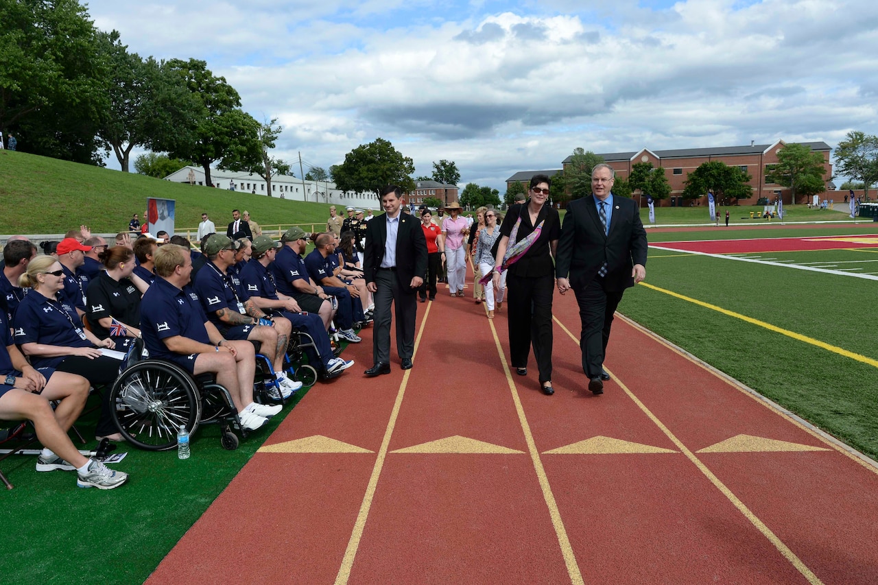 Deputy Defense Secretary Bob Work, right, walks past British athletes during the closing ceremony for the 2015 Department of Defense Warrior Games on Marine Corps Base Quantico, Va., June 28, 2015. DoD photo by Navy Petty Officer 2nd Class Sean Hurt