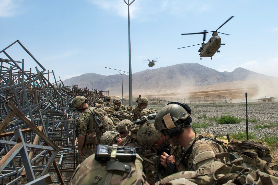 U.S. Army CH-47 Chinook helicopters prepare to land to pick up U.S. troops at an Afghan National Army combat outpost in Afghanistan, June 23, 2015.