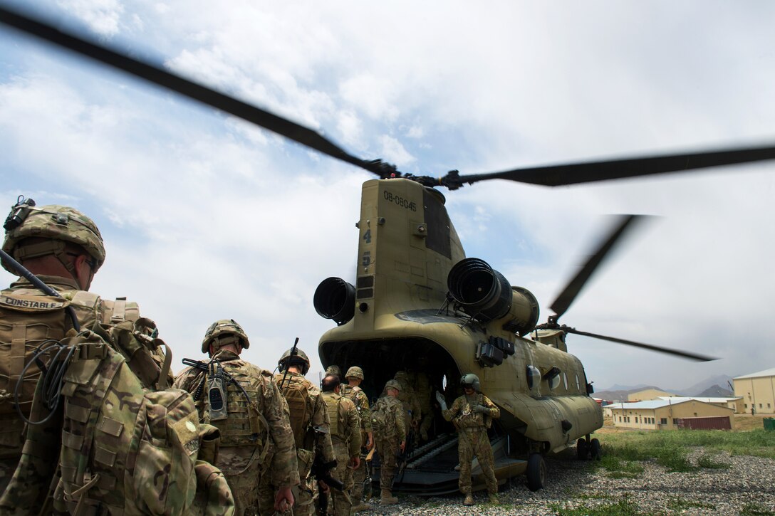 U.S. troops board a U.S. Army CH-47 Chinook helicopter after completing a mission at an Afghan National Army combat outpost in Afghanistan, June 23, 2015.