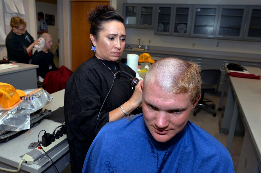 A basic cadet receives a hair cut while in-processing at the U.S. Air Force Academy in Colorado Springs, Colo., June 25, 2015. 