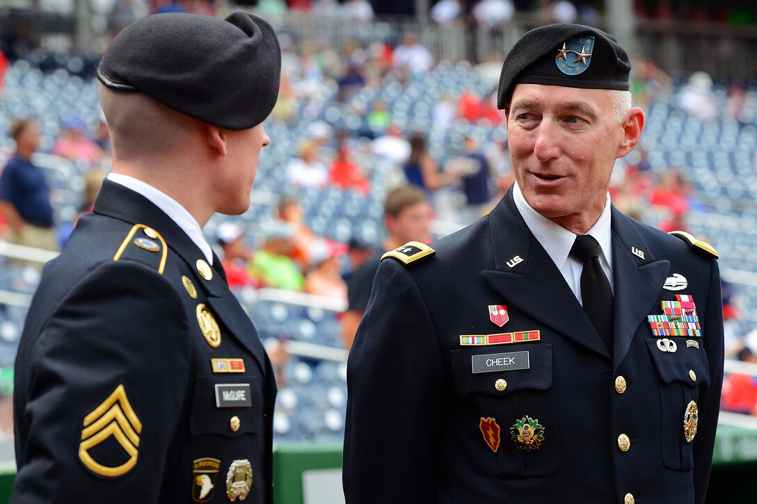 Army Maj. Gen. Gary Cheek, right, talks with Army Staff Sgt. Erik McGuire before a re-enlistment ceremony preceding the Washington Nationals-Atlanta Braves baseball game at Nationals Park in Washington, D.C., June 25, 2015.
