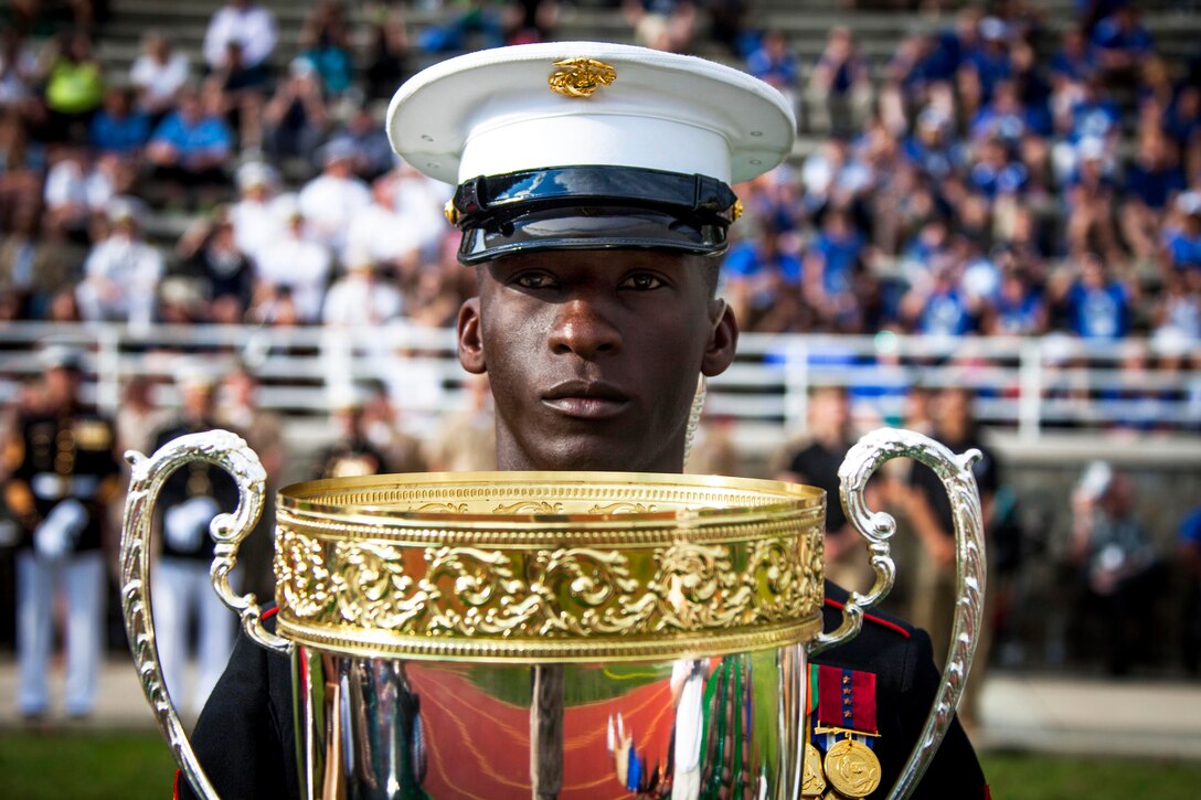A Marine holds the Chairman's Cup during the closing ceremony for the 2015 Department of Defense Warrior Games on Marine Corps Base Quantico, Va., June 28, 2015.