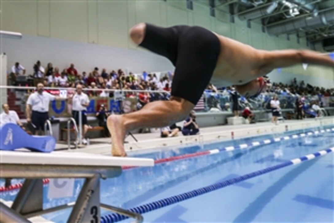 Marine Corps Cpl. Marcus Chischilly dives into the water during the swimming finals at the Freedom Aquatic and Fitness Center in Manassas, Va., June 27, 2015, as part of the 2015 Department of Defense Warrior Games.
