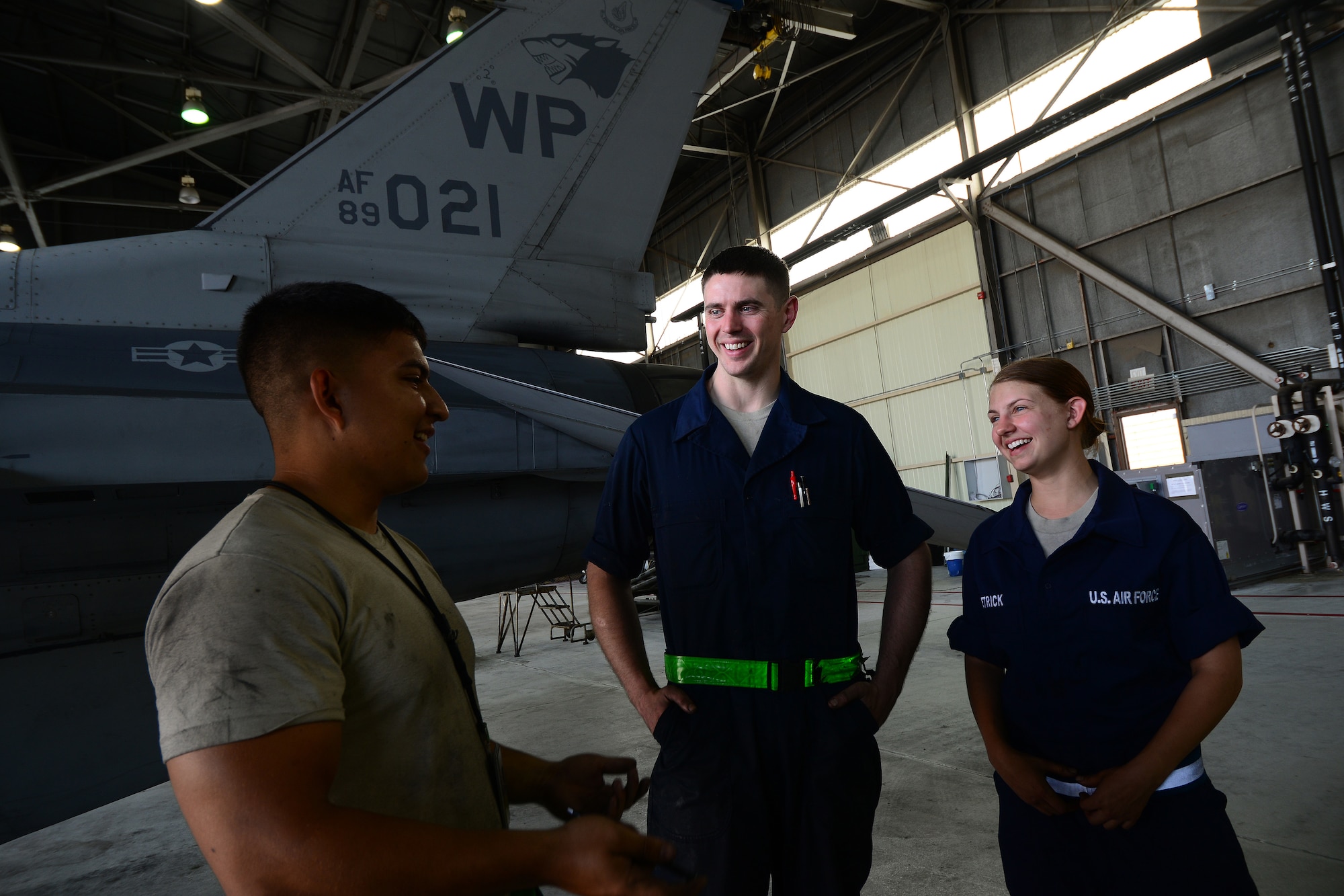 Airman 1st Class Emiliano Silva, 8th Maintenance Squadron inspection section team member, Staff Sgt Dennis Lamm, 8th MXS inspection section floor chief,  and Staff. Sgt. Elizabeth Dietrick, 8th MXS inspection section team member, discuss maintenance operations as part of a phase inspection at Kunsan Air Base, Republic of Korea, June 9, 2015. Dietrick works with a team of Airmen during phase inspections to take an in-depth look at aircraft before and after flight. Phase inspections are performed on aircraft every 400 flight hours and involve procedural maintenance actions that require robust attention to detail. (U.S. Air Force photo by Staff Sgt. Nick Wilson/Released) 