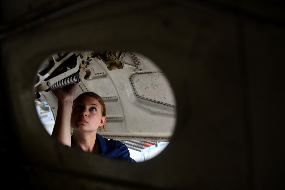 Staff Sgt. Elizabeth Dietrick, 8th Maintenance Squadron inspection section team member, inspects the landing gear of an F-16 Fighting Falcon at Kunsan Air Base, Republic of Korea, June 9, 2015. Dietrick works with a team of Airmen during phase inspections to take an in-depth look at aircraft before and after flight. Phase inspections are performed on aircraft every 400 flight hours and involve procedural maintenance actions that require robust attention to detail. (U.S. Air Force photo by Staff Sgt. Nick Wilson/Released) 