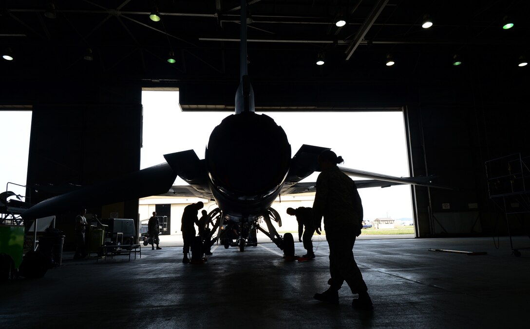 Airmen from the 8th Maintenance Squadron inspection section tow an F-16 Fighting Falcon into a hangar at Kunsan Air Base, Republic of Korea June 9, 2015. This team of Airmen performs phase inspections to take an in-depth look at aircraft before and after flight. Phase inspections are performed on aircraft every 400 flight hours and involve procedural maintenance actions that require robust attention to detail. (U.S. Air Force photo by Staff Sgt. Nick Wilson/Released) 