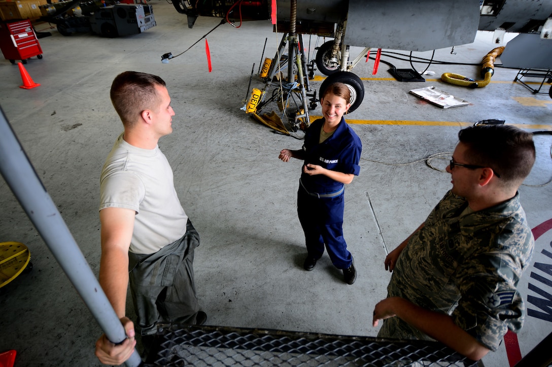 Staff Sgt. Jacob Williams, 8th Maintenance Squadron inspection section team member, discusses maintenance operations with Staff. Sgt. Elizabeth Dietrick, 8th MXS inspection section team member, and Senior Airman Bryce, 8th MXS inspection section team member, at Kunsan Air Base, Republic of Korea, June 9, 2015. Dietrick works with a team of Airmen during phase inspections to take an in-depth look at aircraft before and after flight. Phase inspections are performed on aircraft every 400 flight hours and involve procedural maintenance actions that require robust attention to detail. (U.S. Air Force photo by Staff Sgt. Nick Wilson/Released) 