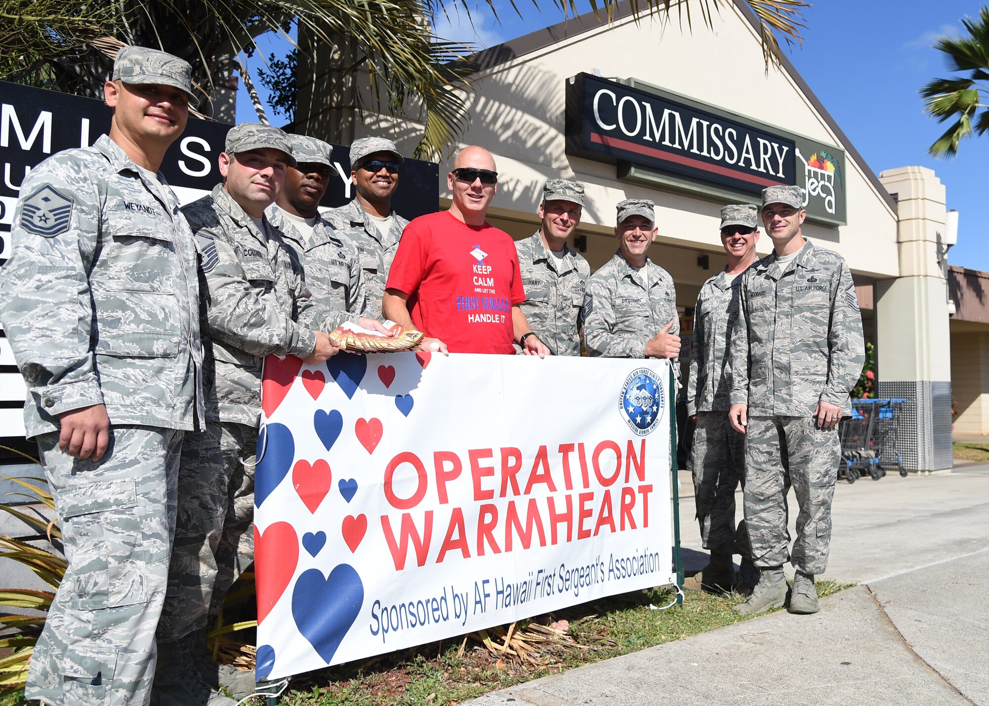 Members of the First Sergeant’s Council supported Operation Warmheart by handing out $1,500 in commissary gift cards to Hickam Commissary customers on Joint Base Pearl Harbor-Hickam, Hawaii, June 27, 2015. First Sergeants from around the base handed out $25 and $50 commissary gift cards to military members E-6 and below and their dependents. The gift card giveaway was a way for Operation Warmheart to give back to the JBPHH community and to let people know that Operation Warmheart is a year-round campaign. (U.S. Air Force Photo by Tech. Sgt. Aaron Oelrich/Released)
