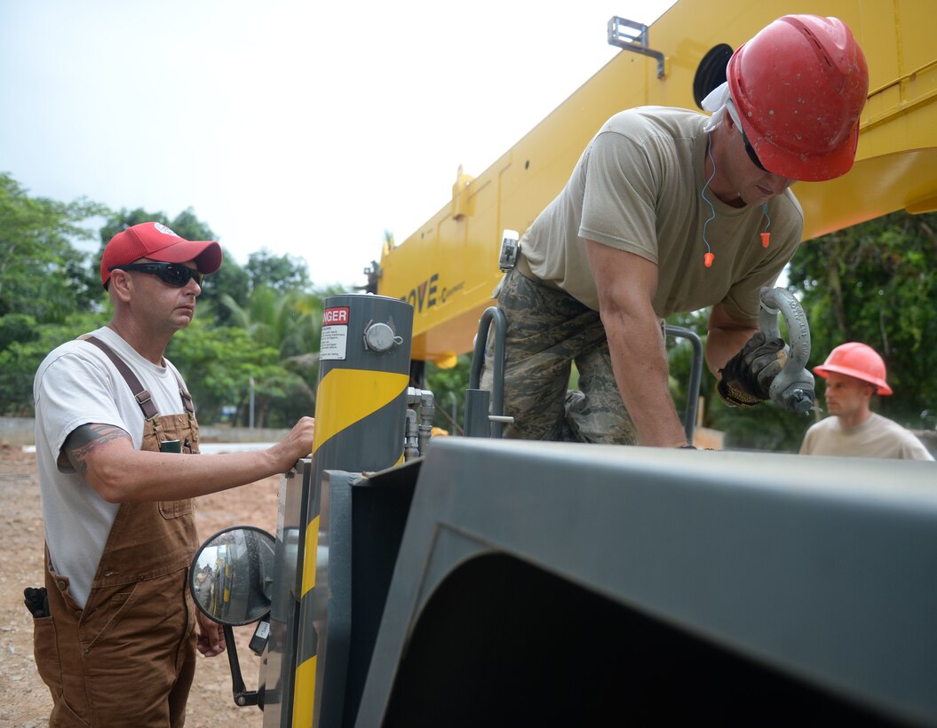 U.S. Air Force Master Sgt. James Gecoma, 823rd Expeditionary RED HORSE Squadron well-drilling superintendent, assists Staff Sgt. Edward Gimzhevskiy, 823rd ERHS heavy equipment operator, with a RT530E-2, Grove Mobile Telescoping Crane, at the Gabriela Mistral school construction site in Ocotes Alto, Honduras, June 24, 2015. The crane will be used to lift the septic tank lids and be used in the construction of the roof. The school project is part of the NEW HORIZONS Honduras 2015 training exercise taking place in and around Tocoa and Trujillo, Honduras. NEW HORIZONS was launched in the 1980s and is an annual joint humanitarian assistance exercise that U.S. Southern Command conducts with a partner nation in Central America, South America or the Caribbean. The exercise improves joint training readiness of U.S. and partner nation civil engineers, medical professionals and support personnel through humanitarian assistance activities. (U.S. Air Force photo by Capt. David J. Murphy/Released)