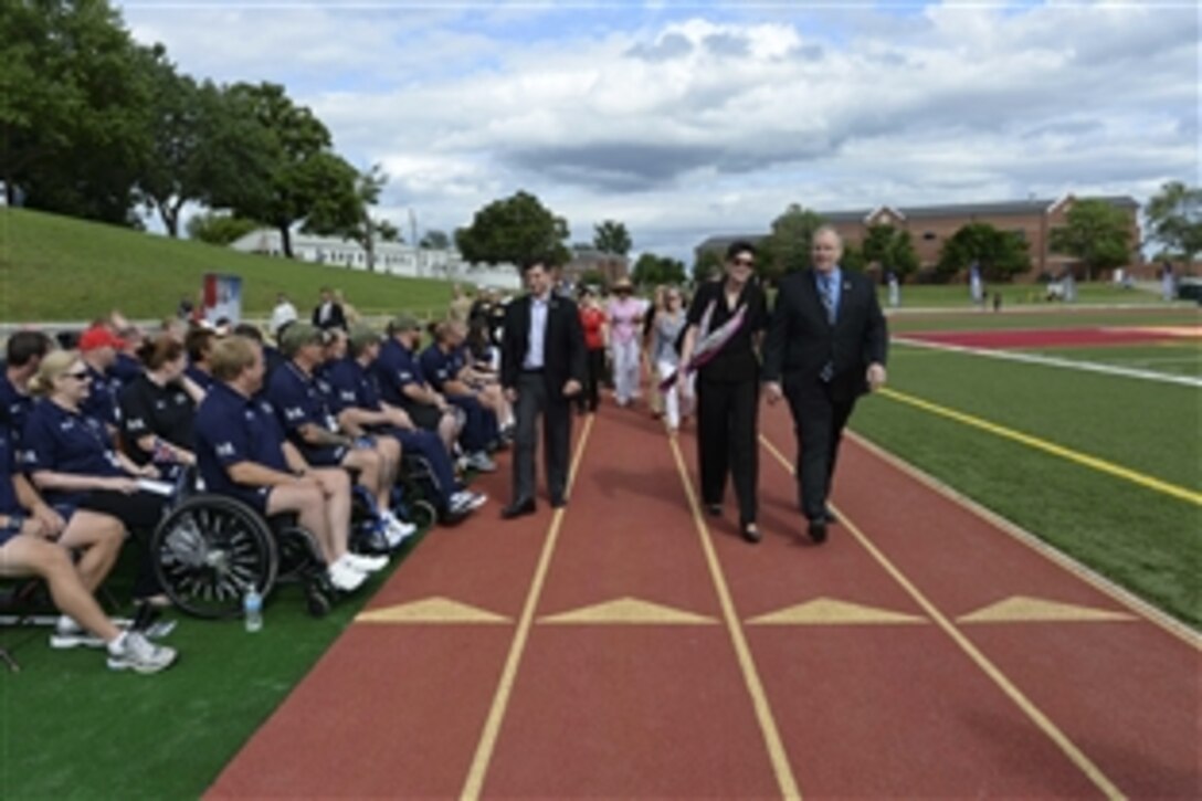 Deputy Defense Secretary Bob Work, right, walks past British athletes during the closing ceremony for the 2015 Department of Defense Warrior Games on Marine Corps Base Quantico, Va., June 28, 2015.