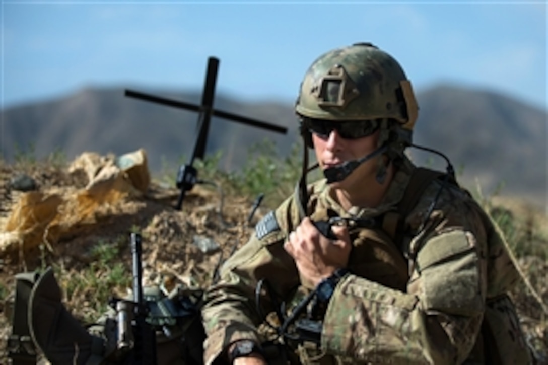 U.S. Air Force Senior Airman Grant Haefke talks to an F-16 Fighting Falcon aircraft pilot during a mission at an Afghan army combat outpost in Afghanistan, June 23, 2015. Haefke, a joint terminal attack controller and tactical air control party airman, is assigned to the 817th Expeditionary Air Support Operations Squadron.